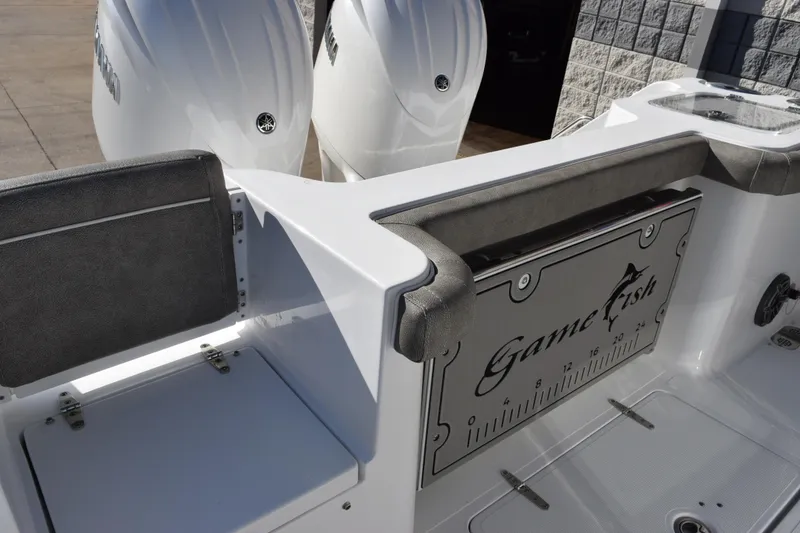 Slide: The Image of 2026 Sea Hunt Gamefish 25 boat interior with dual engines and seating area. - 7