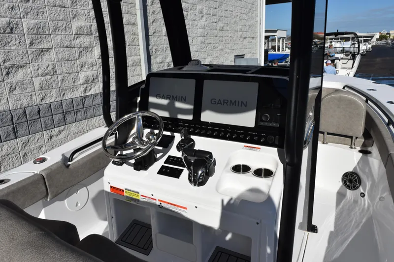 Slide: The Image of 2026 Sea Hunt Gamefish 25 boat cockpit with Garmin navigation system and steering wheel. - 9