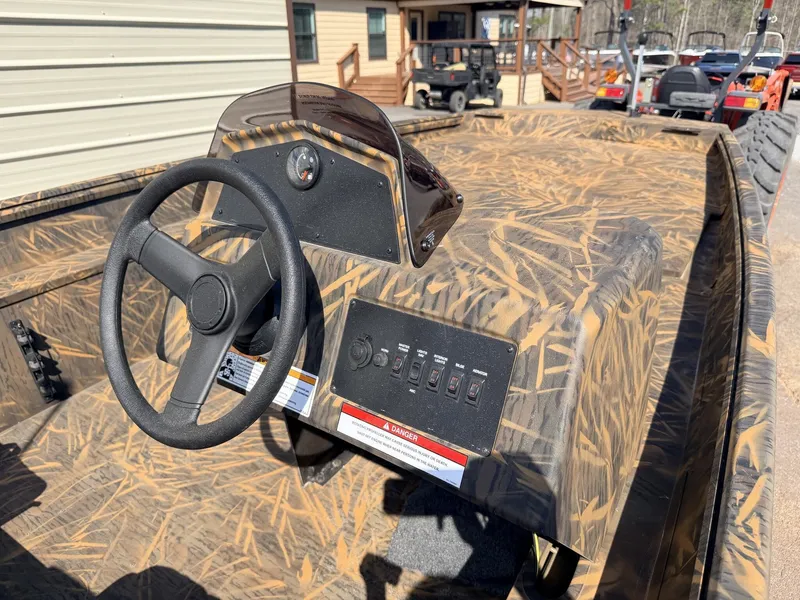 Slide: The Image of 2026 G3 Gator Tough 17 SC-70HP boat console with camouflage design. - 9