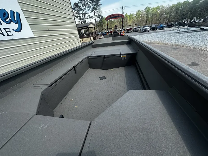 Slide: The Image of Reaper Boats 656 STEP TRANSOM 2026, gray deck, displayed outdoors. - 8