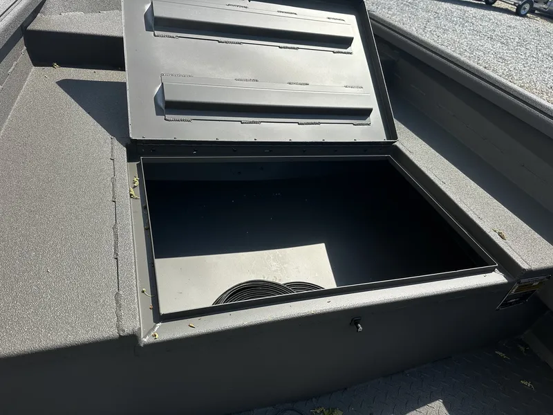 Slide: The Image of Reaper Boats 550 2026 storage compartment with open lid. - 4