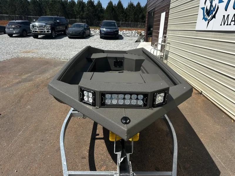 Slide: The Image of 2026 Reaper Boats 550 on a trailer in front of a building. - 5