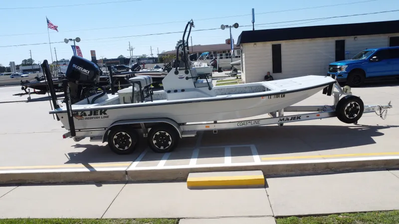 Slide: The Image of 2024 Majek 21RFL boat on trailer parked outdoors. - 7
