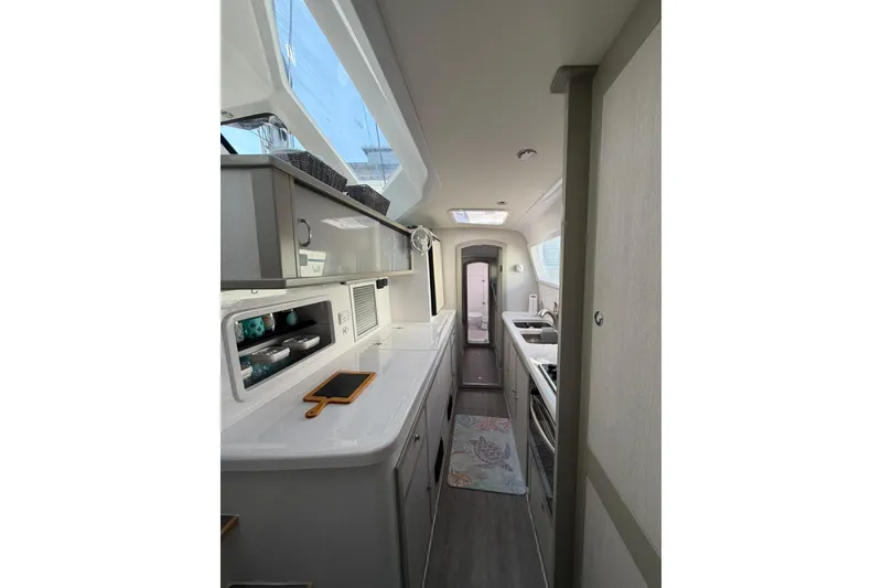 Slide: The Image of Interior of 2022 Seawind 1160 Lite yacht, featuring modern kitchen with ample storage. - 15