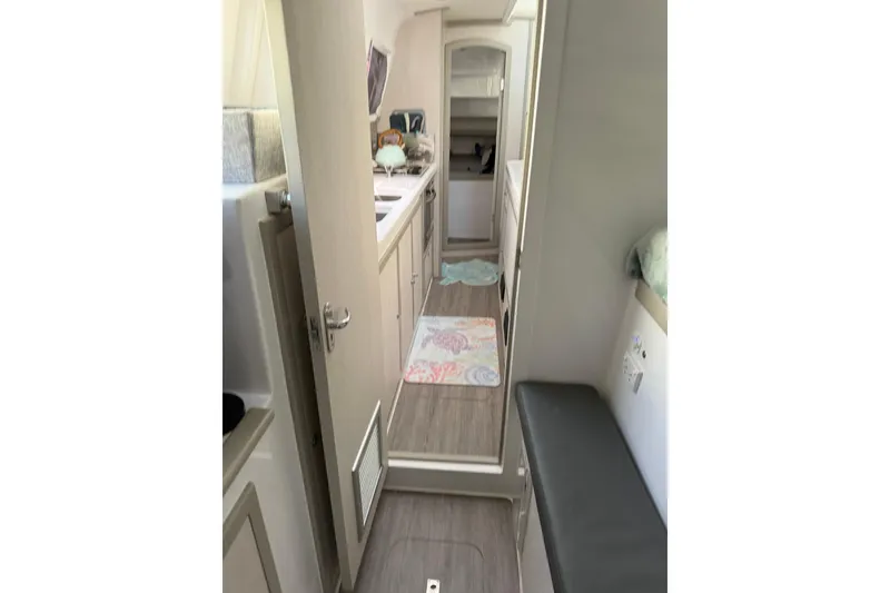Slide: The Image of Interior of 2022 Seawind 1160 Lite catamaran, featuring modern kitchen and seating area. - 17