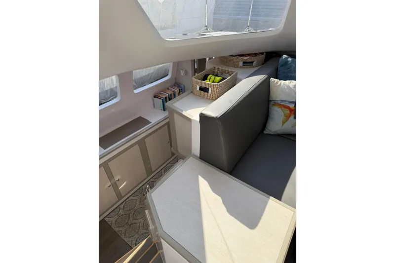 Slide: The Image of Interior of 2022 Seawind 1160 Lite catamaran with cozy seating and storage. - 18