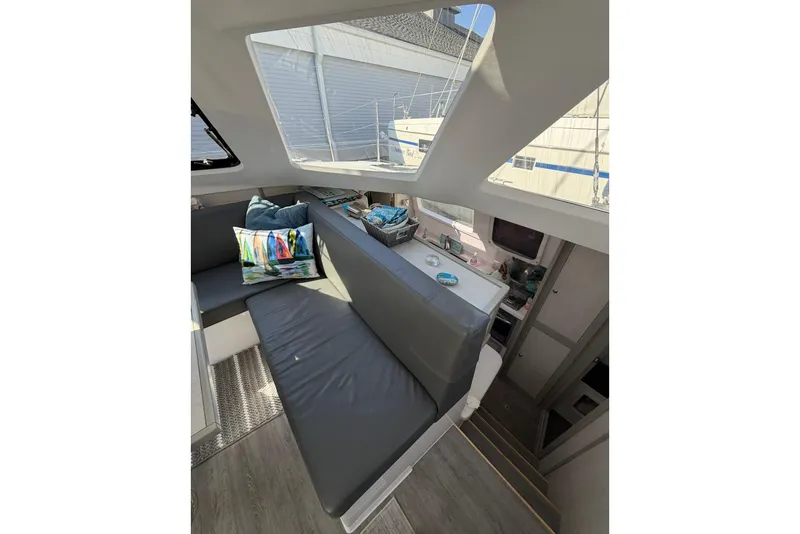 Slide: The Image of Interior of 2022 Seawind 1160 Lite catamaran with modern seating and skylight. - 19