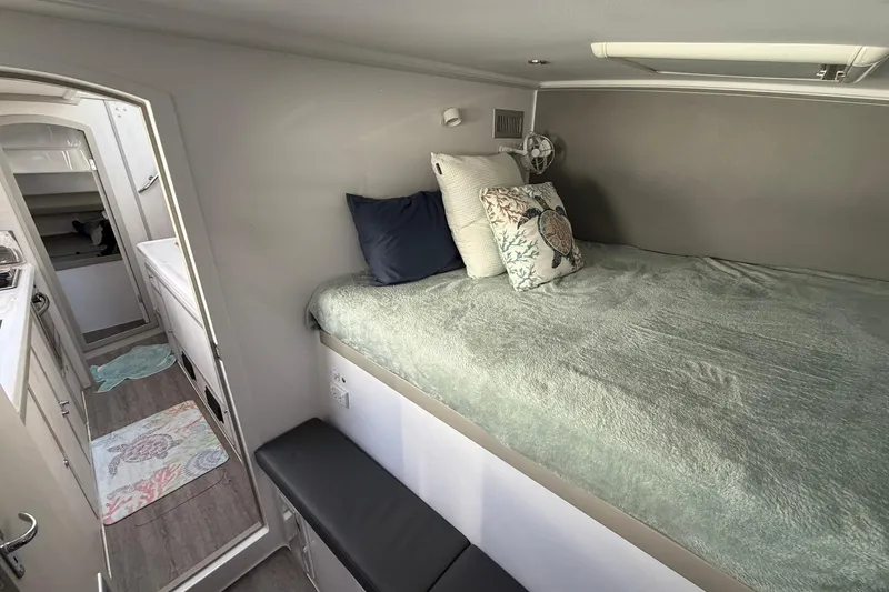 Slide: The Image of Interior of 2022 Seawind 1160 Lite catamaran with cozy bed and modern decor. - 21