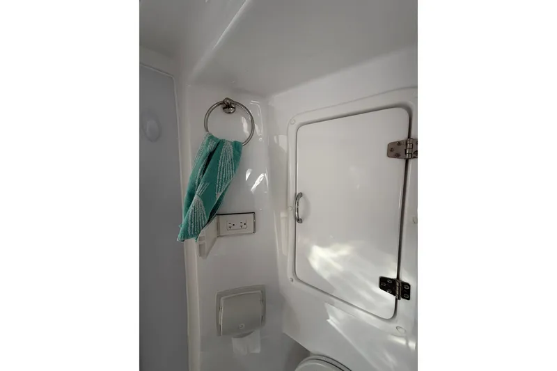 Slide: The Image of Interior of 2022 Seawind 1160 Lite yacht bathroom with towel and storage compartment. - 29