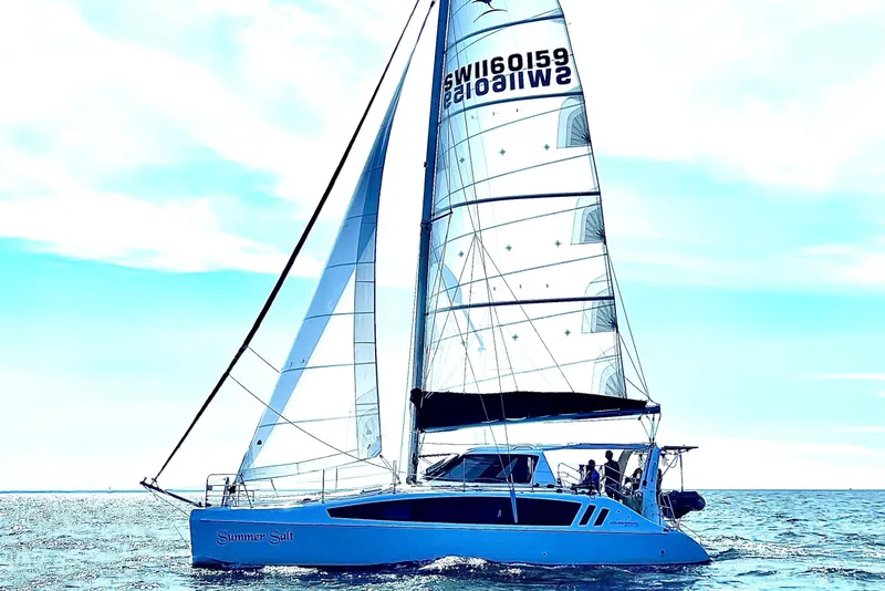 Slide: The Image of 2022 Seawind 1160 Lite sailing on open water under clear skies. - 4