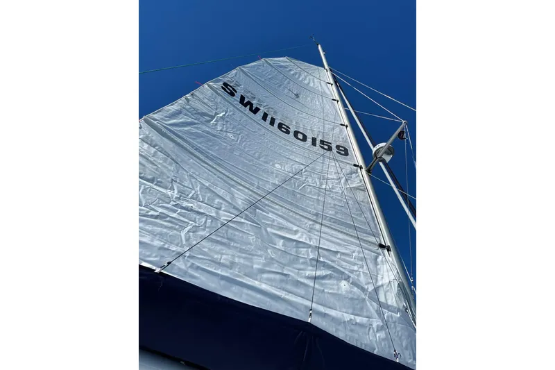 Slide: The Image of Sail of 2022 Seawind 1160 Lite catamaran with diesel motors against clear blue sky. - 6