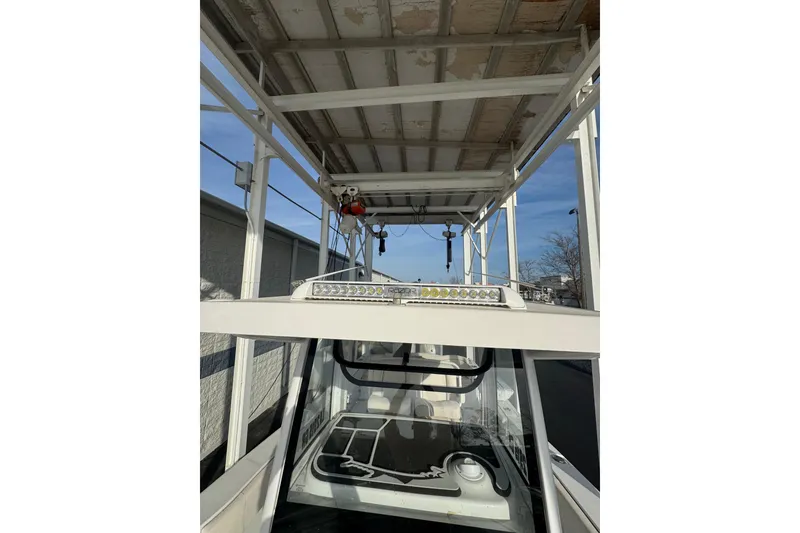 Slide: The Image of 2023 Sea Hunt Ultra 305 SE boat with overhead structure and LED lights. - 10
