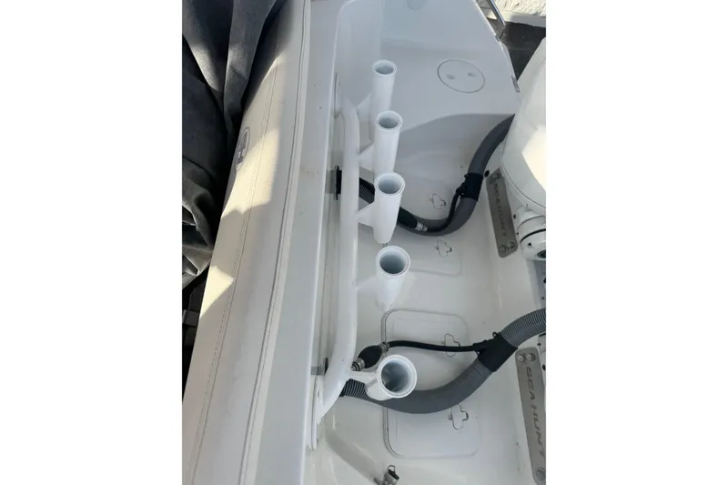 Slide: The Image of 2023 Sea Hunt Ultra 305 SE boat interior with rod holders and storage compartments. - 11