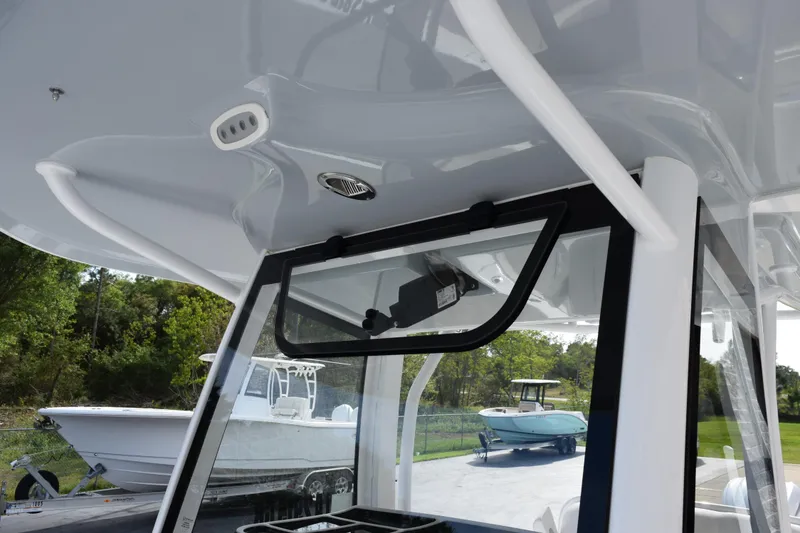Slide: The Image of 2023 Sea Hunt Ultra 305 SE boat interior with open window and sleek design. - 16