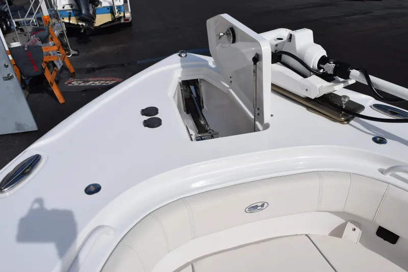 Slide: The Image of 2023 Sea Hunt Ultra 305 SE boat deck with open storage compartment. - 17