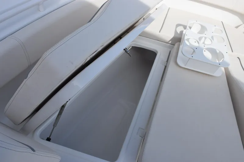 Slide: The Image of 2023 Sea Hunt Ultra 305 SE boat storage compartment with cup holders. - 20