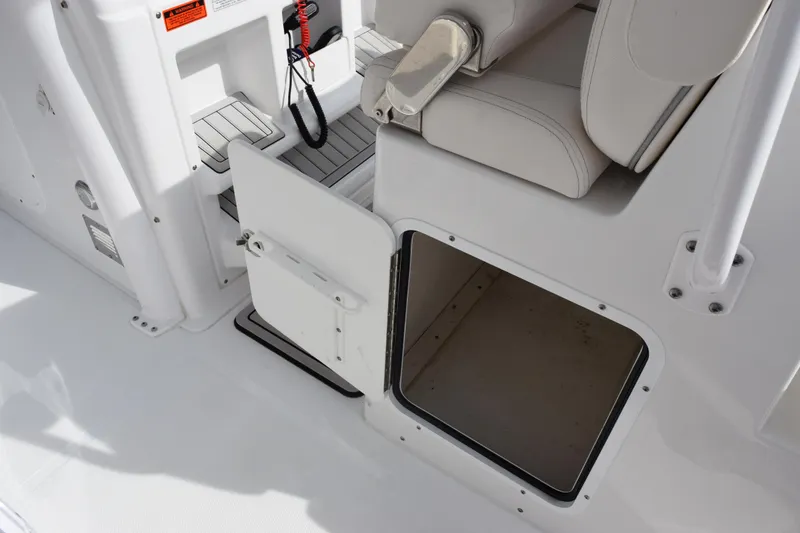 Slide: The Image of 2023 Sea Hunt Ultra 305 SE boat storage compartment and seating detail. - 25