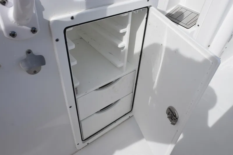 Slide: The Image of Open storage compartment on 2023 Sea Hunt Ultra 305 SE boat. - 27