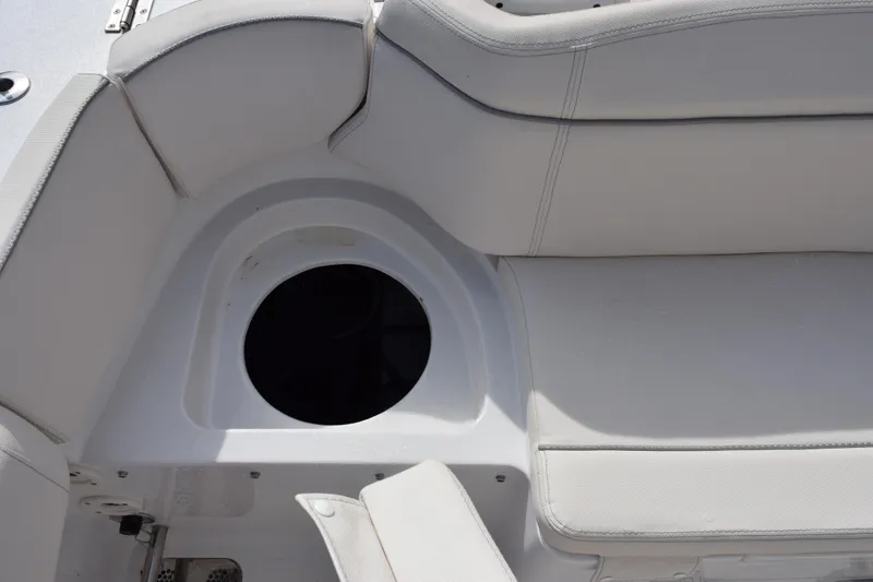 Slide: The Image of 2023 Sea Hunt Ultra 305 SE boat seating area with storage compartment. - 29