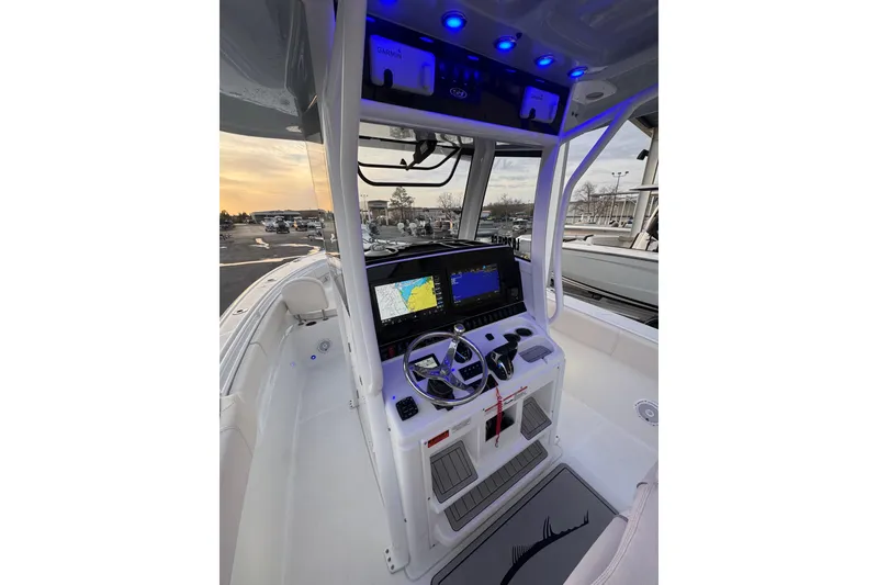 Slide: The Image of 2023 Sea Hunt Ultra 305 SE boat cockpit with advanced navigation system and illuminated controls. - 3