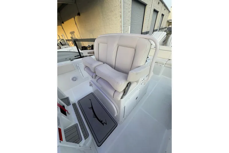 Slide: The Image of 2023 Sea Hunt Ultra 305 SE boat with plush white seating and sleek design. - 4
