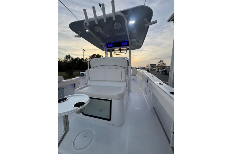Slide: The Image of 2023 Sea Hunt Ultra 305 SE boat interior with seating and overhead console. - 5