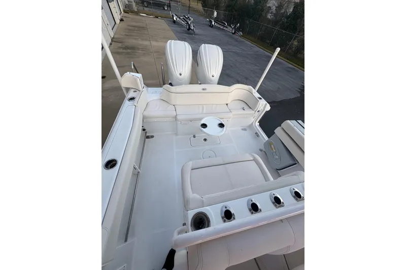 Slide: The Image of 2023 Sea Hunt Ultra 305 SE boat interior with seating and rod holders. - 6