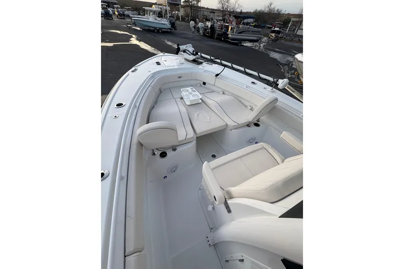 Slide: The Image of 2023 Sea Hunt Ultra 305 SE boat interior with white seating and cup holders. - 8