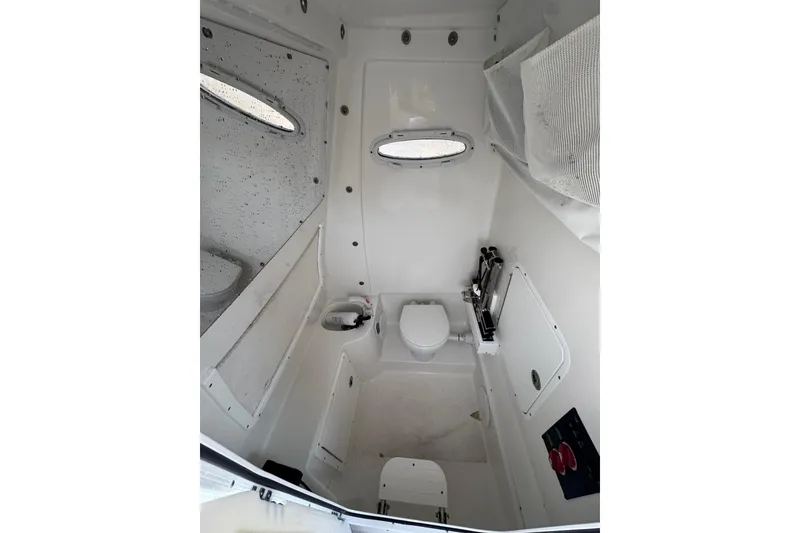 Slide: The Image of 2023 Sea Hunt Ultra 305 SE boat interior with compact bathroom amenities. - 9
