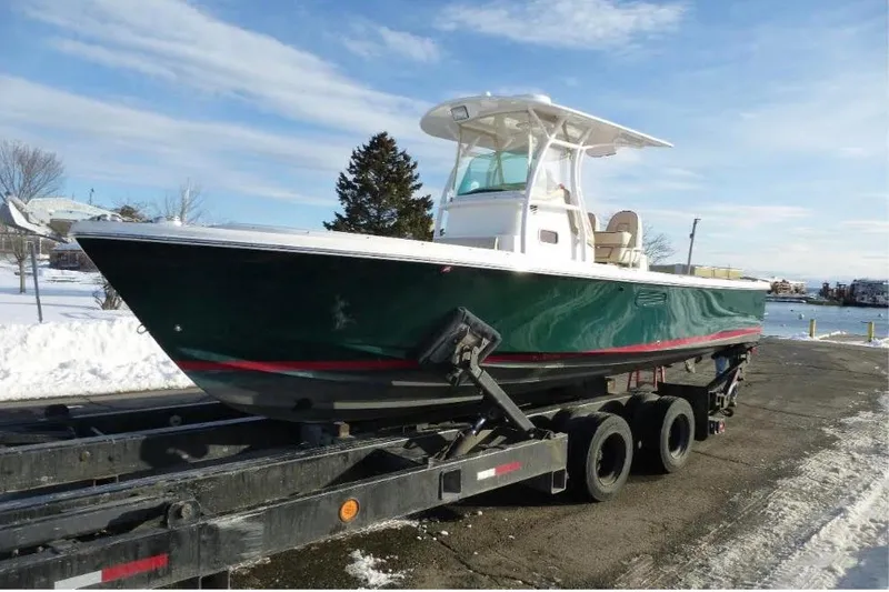 The Image of 2008 Hunt Yachts Surfhunter 25 Center Console on trailer, snowy background. - 0