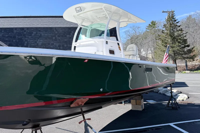 Slide: The Image of 2008 Hunt Yachts Surfhunter 25 Center Console boat on display in a parking lot. - 11