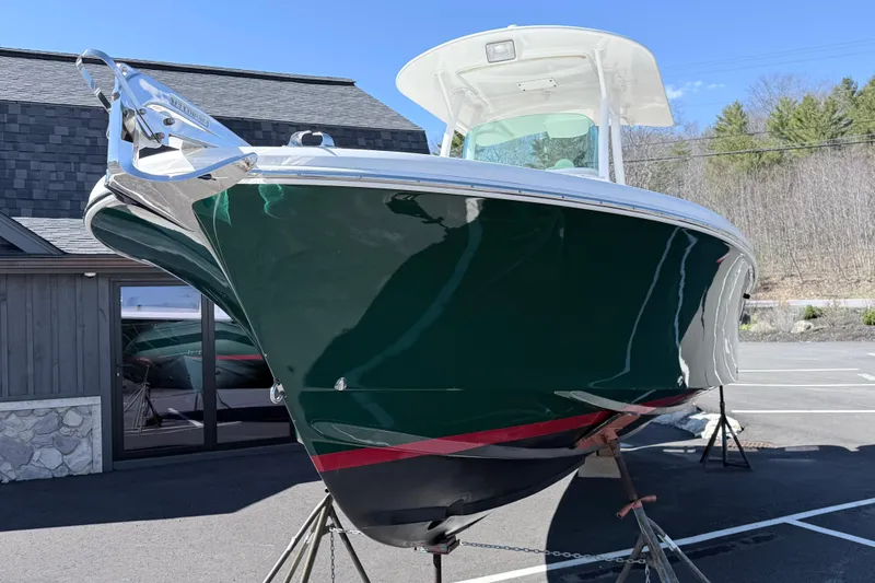 Slide: The Image of 2008 Hunt Yachts Surfhunter 25 Center Console, green hull, displayed outdoors. - 13