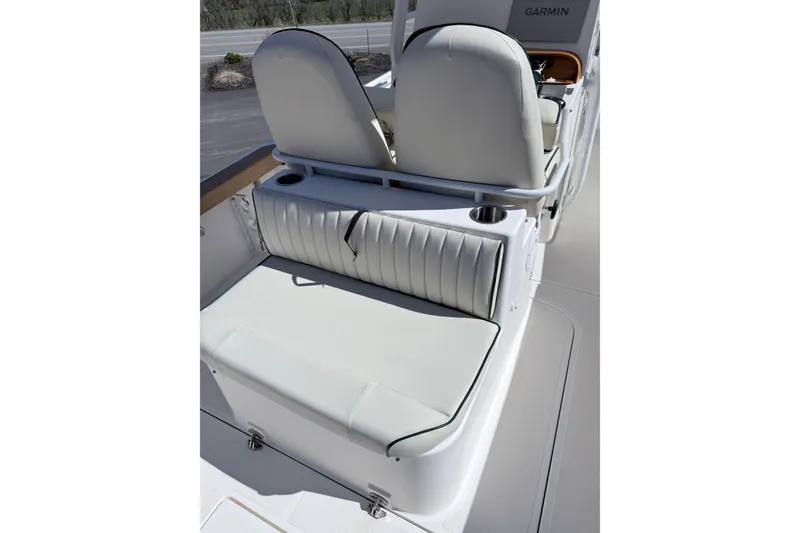 Slide: The Image of 2008 Hunt Yachts Surfhunter 25 Center Console seating area with cushioned seats and cup holder. - 16