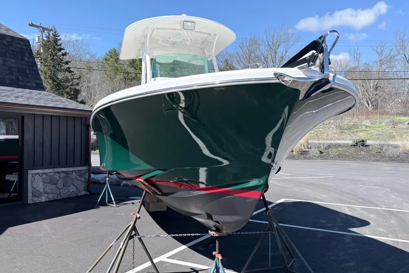 Slide: The Image of 2008 Hunt Yachts Surfhunter 25 Center Console on stands, green hull, outdoor setting. - 7