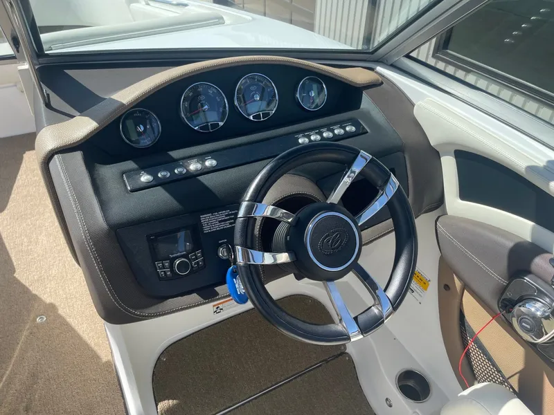 Slide: The Image of Interior view of 2016 Cobalt 24SD boat cockpit with steering wheel and gauges. - 11