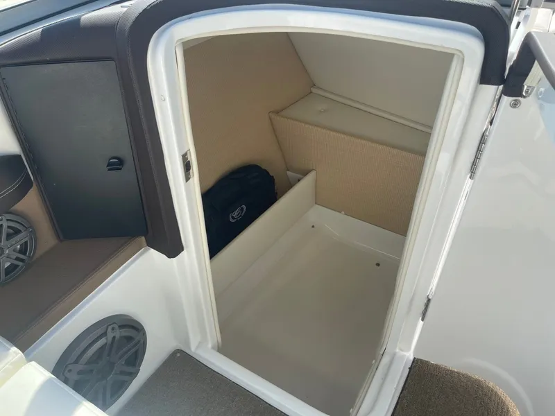Slide: The Image of Interior of a 2016 Cobalt 24SD boat with storage space. - 18