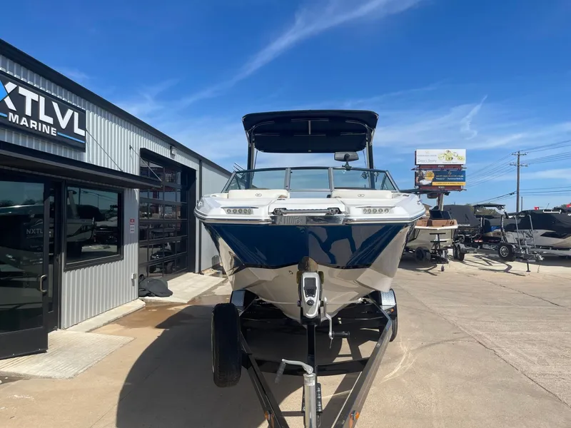 Slide: The Image of 2016 Cobalt 24SD boat in front of a marine shop. - 3