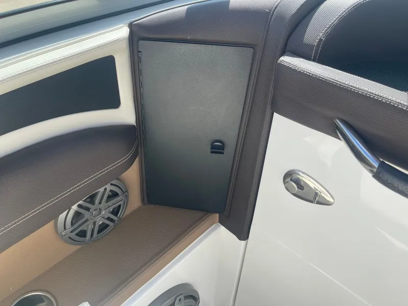 Slide: The Image of Interior of a 2016 Cobalt 24SD boat with speaker and storage compartment. - 30