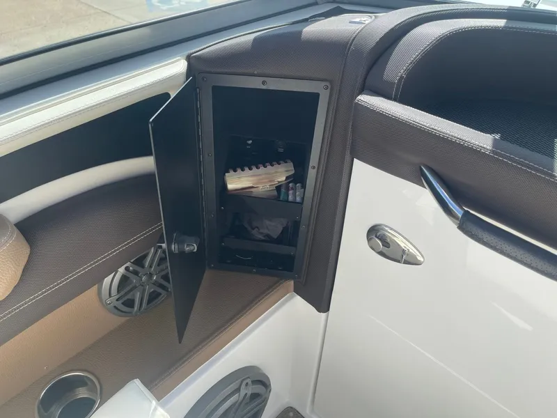 Slide: The Image of Open storage compartment in a 2016 Cobalt 24SD boat. - 31