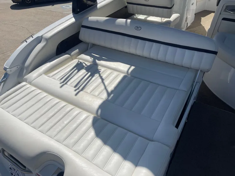Slide: The Image of Interior of a 2016 Cobalt 24SD boat with white leather seating. - 9