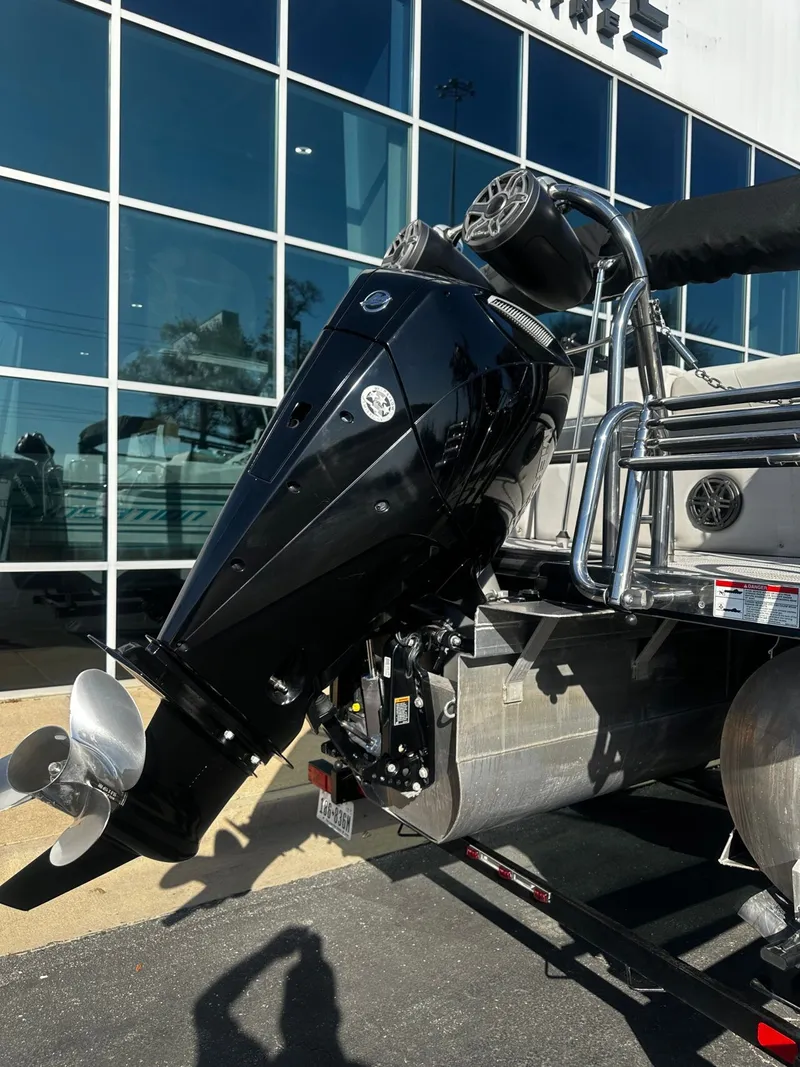 Slide: The Image of 2022 Harris Sunliner 250 outboard motor in front of glass building. - 15