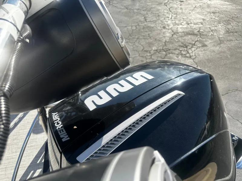 Slide: The Image of Close-up of a Mercury engine on a 2022 Harris Sunliner 250. - 22