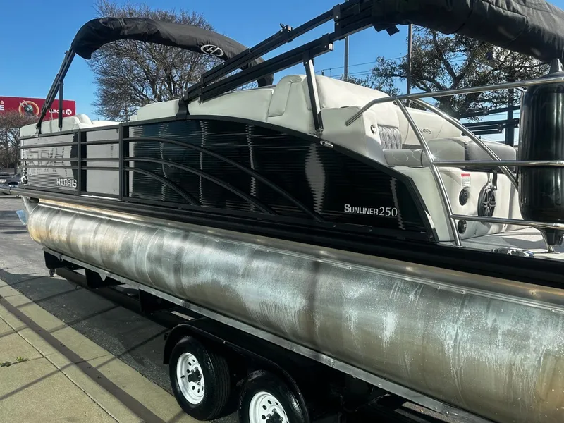 Slide: The Image of 2022 Harris Sunliner 250 pontoon boat on a trailer. - 5