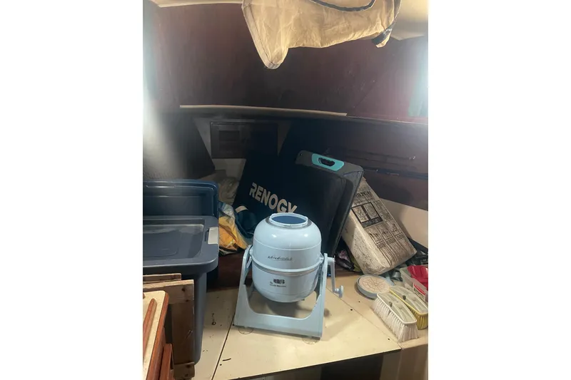 Slide: The Image of Interior of Irwin 37 Mk V sailboat with portable washing machine and storage items. - 10