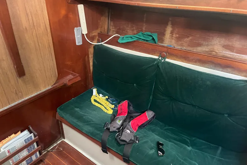 Slide: The Image of Interior of Irwin 37 Mk V sailboat with green cushioned seating and safety gear. - 11