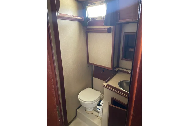 Slide: The Image of Compact bathroom in Irwin 37 Mk V sailboat with toilet, sink, and storage. - 12