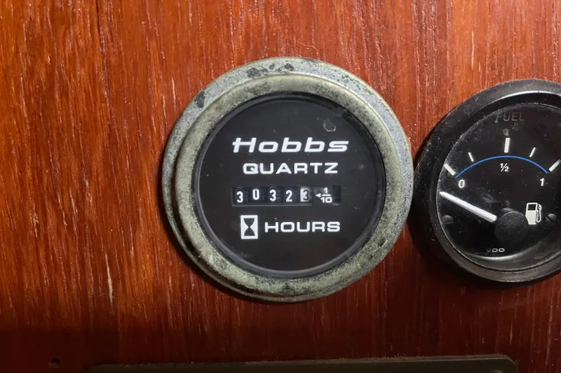 Slide: The Image of Hour meter and fuel gauge on Irwin 37 Mk V boat dashboard. - 13