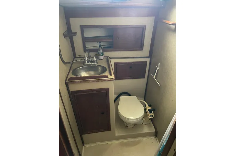 Slide: The Image of Compact bathroom in Irwin 37 Mk V sailboat with sink, toilet, and storage cabinets. - 15