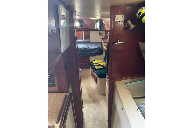Slide: The Image of Interior of Irwin 37 Mk V sailboat, featuring cozy cabin with wooden furnishings. - 16