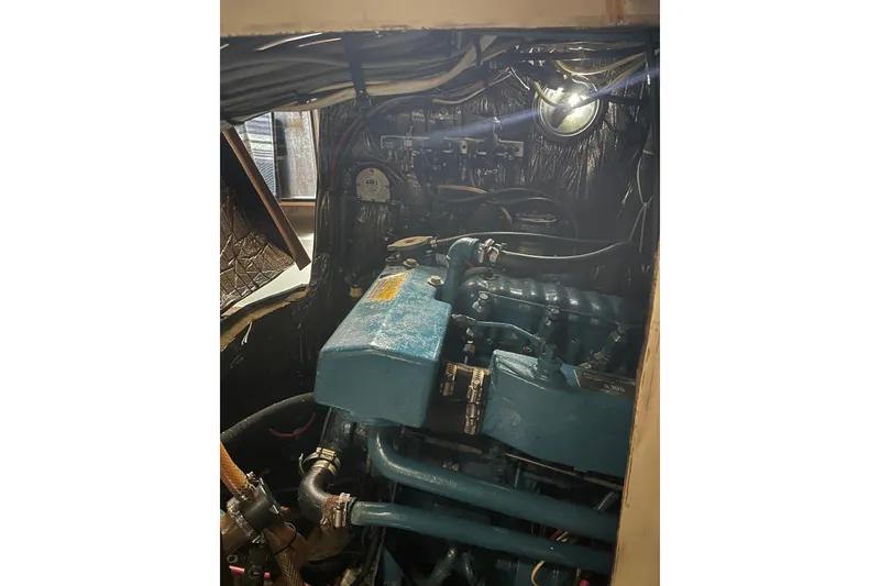 Slide: The Image of Engine compartment of Irwin 37 Mk V sailboat, showcasing mechanical components and wiring. - 20